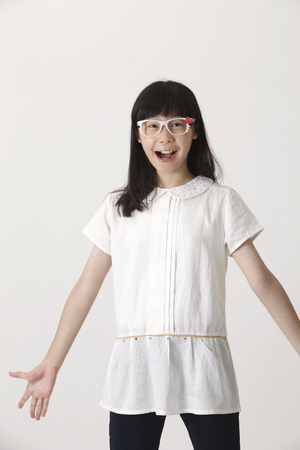 happy girl standing with hand openの写真素材