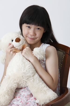 Chinese girl hugging soft toyの写真素材