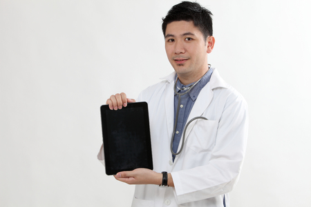 chinese doctor holding a digital tabletの写真素材