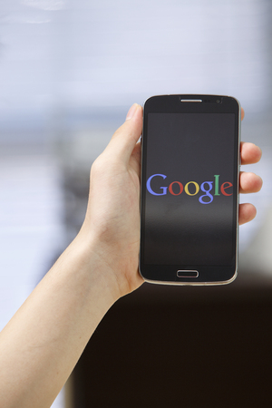 Kuala Lumpur,Malaysia 9th April 2015,Kuala Lumpur,Malaysia 9th April 2015, Young man Using Google Web Search on her Smart Phone.のeditorial素材