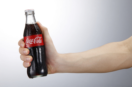 Kuala Lumpur,Malaysia 9th April 2015,Photo of a hand holding glass bottle of Coca Cola - Refreshing. Wet with water ice dropletsのeditorial素材