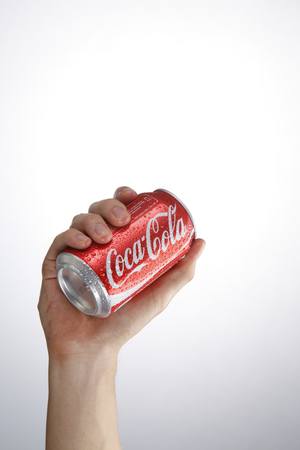 Kuala Lumpur,Malaysia 9th April 2015, hand holding a red Coca Cola can drinks.Coca Cola drinks are produced and manufactured by The Coca-Cola Companyのeditorial素材