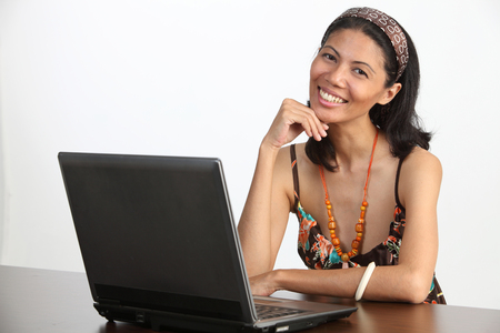 malay woman sitting in front of computerの写真素材