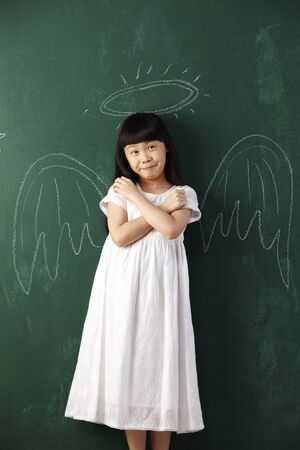 chinese girl  in front of blackboardの写真素材