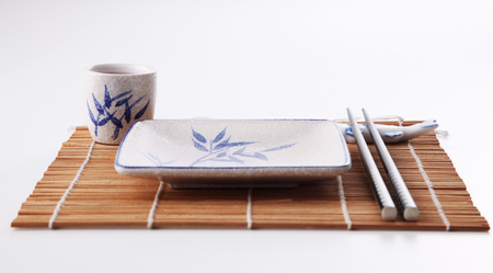 Empty dishes for sushi and rolls on a bamboo plateの写真素材