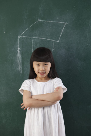 student standing in front of black board with drawingの写真素材