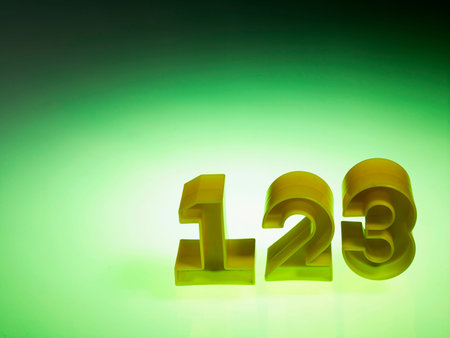 plastic numbers 123 on green backgroundの写真素材