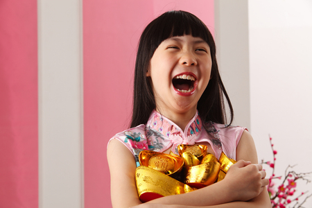 little girl holding bunch on ingotの写真素材