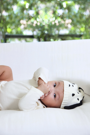 Baby laying down and looking at cameraのeditorial素材