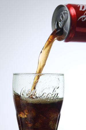 KUALA LUMPUR, MALAYSIA - Feb 17, 2016 pouring coca cola to a glass with ice cube