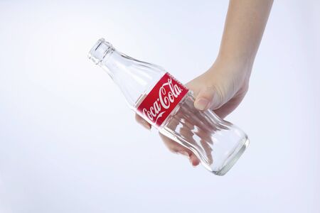 kuala lumpur-malaysia, 16th november 2015, female hand holding  empty  coca cola glass bottleのeditorial素材