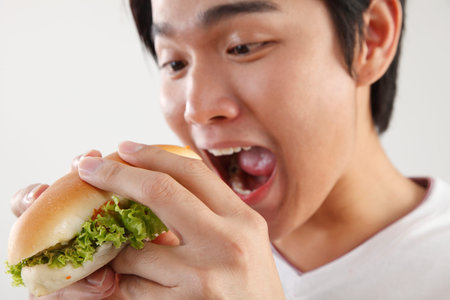 man eating burger on the white background