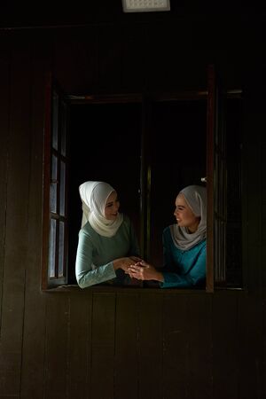 woman greeting each others that invited for the celebration of Hari Raya. They are all excited to enjoy the festivity for the day.の写真素材
