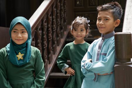 Malay family in Malay traditional showing their happy reaction during Hari Raya celebration.の写真素材