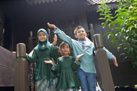 Malay family in Malay traditional showing their happy reaction during Hari Raya celebration.の写真素材