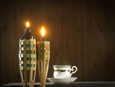 bamboo torch or pelita with cup of hot teaの写真素材