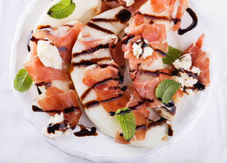 Salad melon with Serrano ham on a white background.selective focusの写真素材