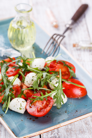 Vegetable salad,cherry tomatoes,, mini mozzarella, arugula. selective focusの写真素材