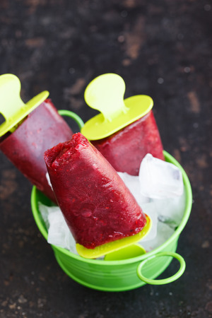 BlackBerry ice cream on a stick,fruit, against a dark background.selective focusの写真素材