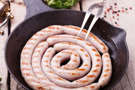 Sausages fried homemade frying in a cast iron skillet, composition spiral.selective focusの写真素材