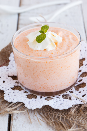 Pumpkin mousse,decorated with mint leaves and whipped cream  in a glass beaker.selective focusの写真素材