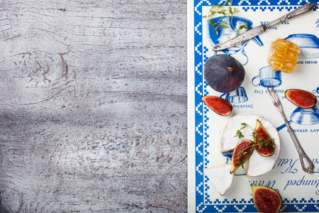 Cheese Board,appetizer.Brie cheese,figs,blueberries,honey and thyme.Copy space.selective focusの写真素材