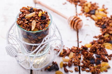 Granola, honey, raisins, peanuts and sunflower seeds.の写真素材