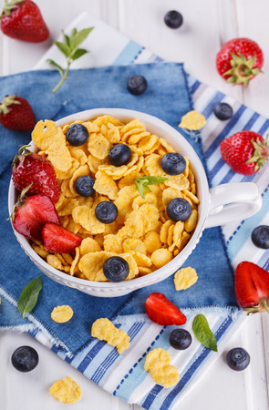 Corn flakes and fresh berries, for Breakfast. selective focusの写真素材