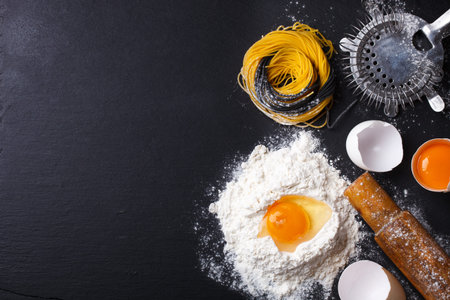 Raw homemade pasta and ingredients on a black background.selective focus..Copy space.の写真素材