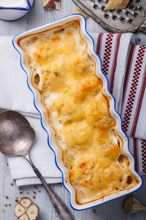 Gratin of cauliflower, potatoes and cheese in a ceramic form.selective focusの写真素材