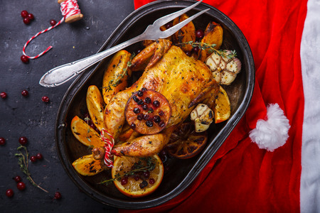 Chicken baked with oranges , cranberries ,garlic for Christmas.Thanksgiving Dinner. selective focus.の写真素材