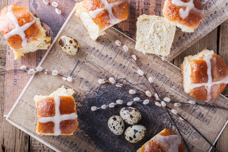 Easter Hot Cross Buns on wooden background.