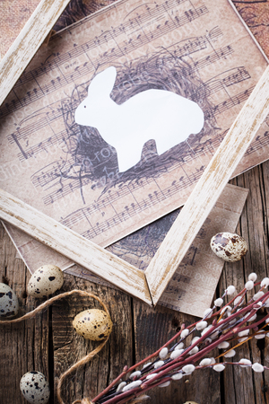 Quail eggs and willow,a rabbit in wooden frameの写真素材