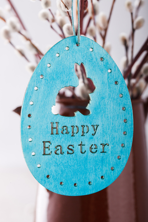 Willow, wooden rabbit, in a vintage vase, a symbol of Easter.selective focus.の写真素材