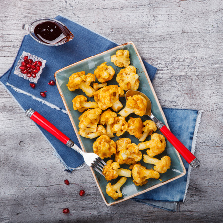 Fried cauliflower in spices with pomegranate sauce.selective focus.の写真素材