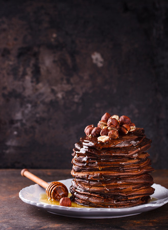 Chocolate pancake with honey and hazelnuts.selective focusの写真素材