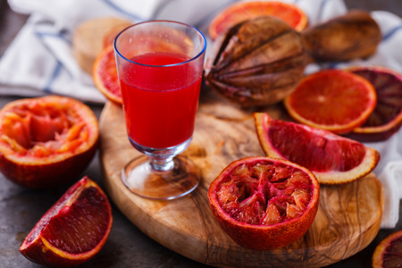 blood orange,freshly squeezed orange juice,on a wooden Board.selective focus.の写真素材