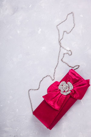 Still life of fashion woman. background.Women's set of fashion accessories in pink color,clutch bag.Copy space.selective focus.の写真素材