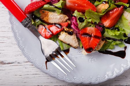 Salad with fresh strawberries,herbs and chicken meat,tossed with balsamic vinaigrette. Healthy food or diet concept.selective focus.の写真素材