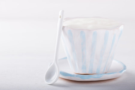 Yogurt,homemade in a ceramic bowl  on a white background.Breakfast.Healthy food or diet concept.selective focus.の写真素材