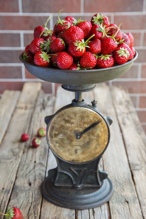 Vintage scales with fresh strawberries. Vintage style. selective focus.の写真素材