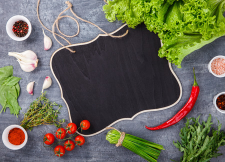 Fresh salad greens of lettuce with spices and fresh vegetables. Vegetarian and healthily cooking concept. Copy space. selective focusの写真素材