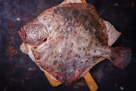 Flounder raw fish on a dark background.selective focus.の写真素材