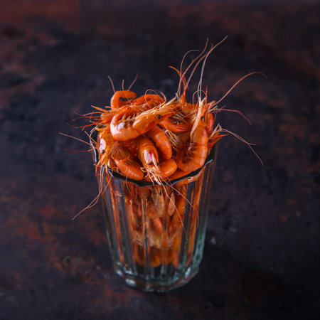 Prawn shrimp cooked in a glass beaker on a dark background.Crustaceans and seafood. selective focus.の写真素材