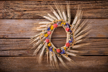 Wreath of ears of corn and dried flowers. Vintage style. Autumn Background. Selective focus. Top view.の写真素材