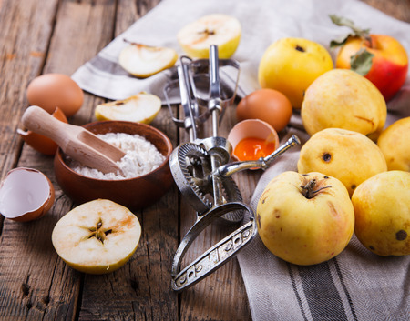 Baking Background. Ingredients  for baking Apple Pie  - apples, spices ,flour,  rolling pin, eggs, egg yolks, butter served. Vintage style. selective focus. Top view.の写真素材