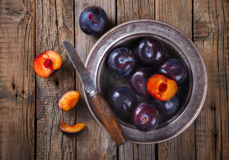 Plum in plate on a blue background. selective focus.の写真素材