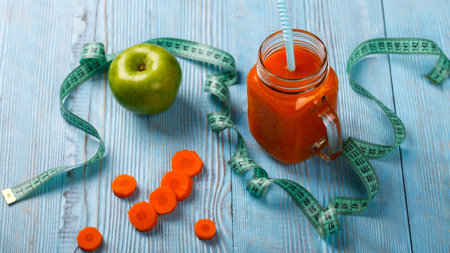 Freshly squeezed Carrot and
Apple juice in glass   on wooden background. Healthy food or diet concept.の写真素材