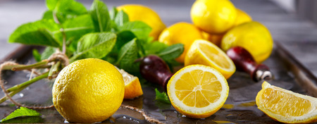 Lemons fresh.Citrus on metallic Background with green mint and pieces of ice.Mojito.selective focus.の写真素材