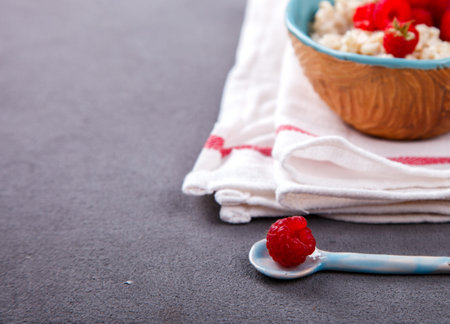 Oatmeal Porridge with fresh Berries,Raspberry.Breakfast.Concept of Healthy Eating. Copy...